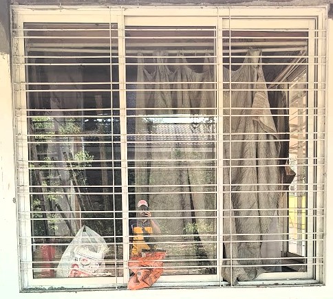 A simple yet strong MS window grill with vertical bars for security.